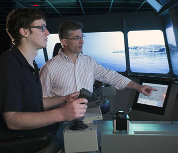 two men in littoral combat ship simulator