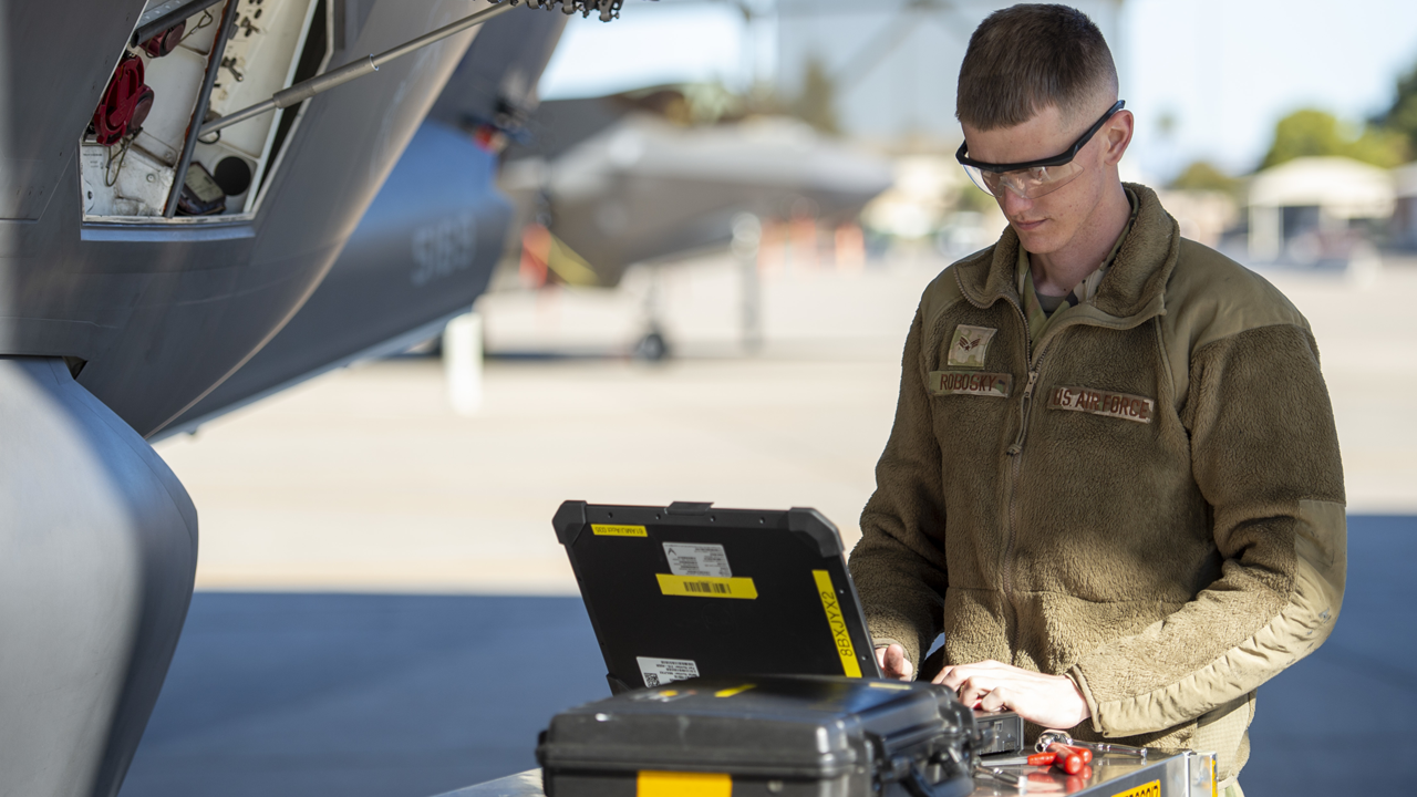 Soldier typing on laptop