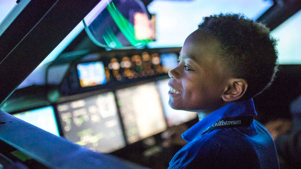 young student in Gulfstream's flight simulator during its Pilot for a Day program 