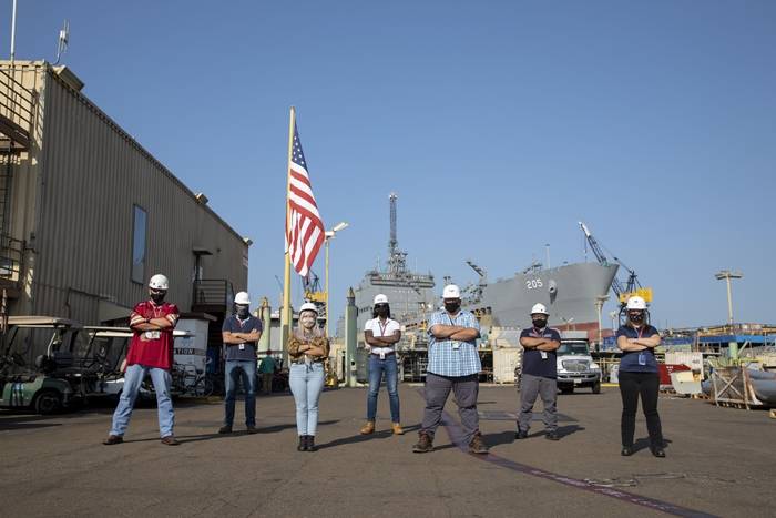 NASSCO employees in shipyard wearing masks 