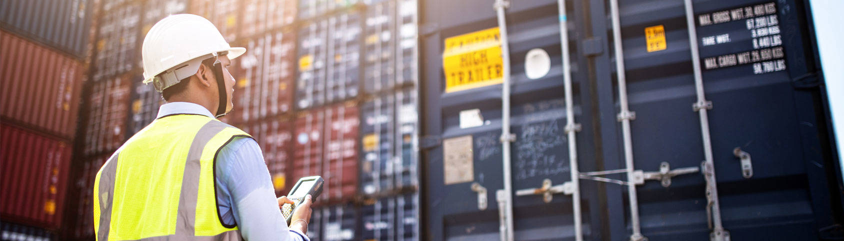 Man looking at shipping containers